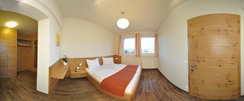 a bedroom with a bed and a wooden door at Karglhof Stammhaus in Faak am See