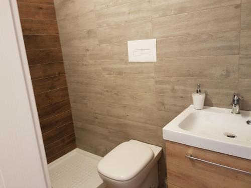 a bathroom with a toilet and a sink at Il corso Favignana in Favignana