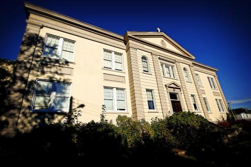 a large white building with windows on top of it at Monastery Hotel in St. John's