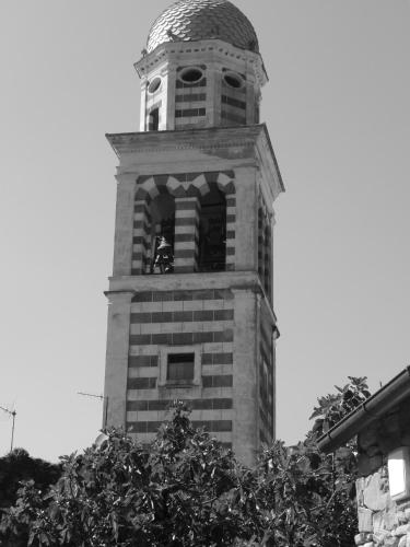 a tall tower with a clock on top of it at B&B Piè del Castello in Levanto