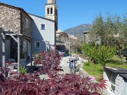 a bike parked next to a building with a clock tower at B&B Piè del Castello in Levanto