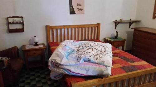 a bedroom with a bed with a comforter on it at Casa Sol da Praia - Praia de Odeceixe in Odeceixe