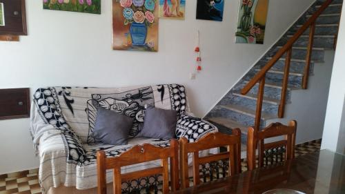 a living room with a couch and a staircase at Casa Sol da Praia - Praia de Odeceixe in Odeceixe