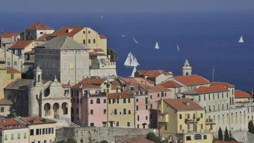 a group of buildings on a hill next to the ocean at Casa vacanze Cristina in Imperia