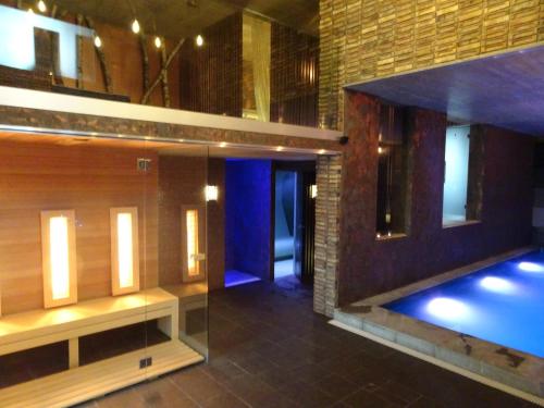 a room with a swimming pool in a building at Penzion Zlaty Orol in Helcmanovce