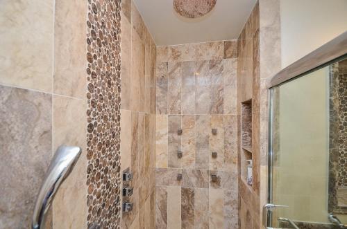 a bathroom with a shower with a glass door at Houston Towers Inn, Adults-Only, Downtown, Med Ctr, NRG in Houston