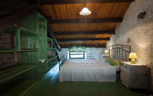 a bedroom with two beds in a room with wooden ceilings at Holiday Home Ladonja in Manjadvorci