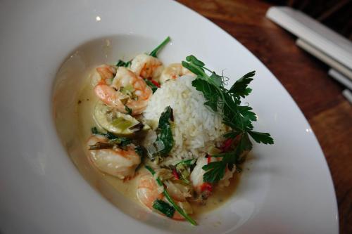 a white plate with shrimp and rice on a table at Hedley House Hotel & Apartments in York