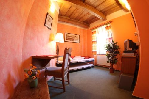 a room with a desk and a chair and a bed at Mahleruv Penzion Na Hradbach in Jihlava