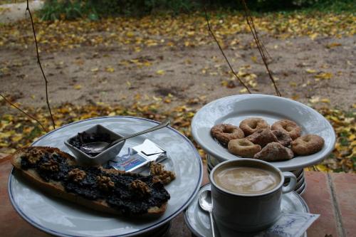 a table with two plates of food and a cup of coffee at Casas Rurales Los Enebros Nerpio in Nerpio