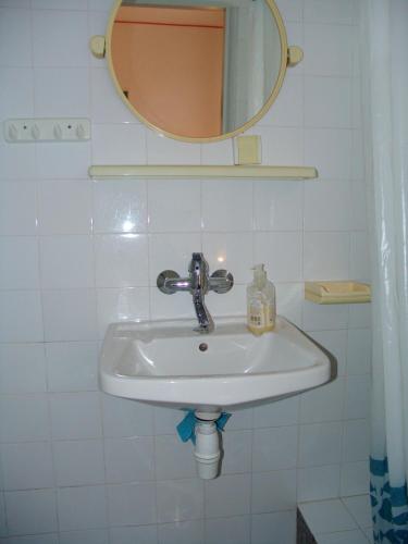 a white sink in a bathroom with a mirror at Sobe Bozica in Krk