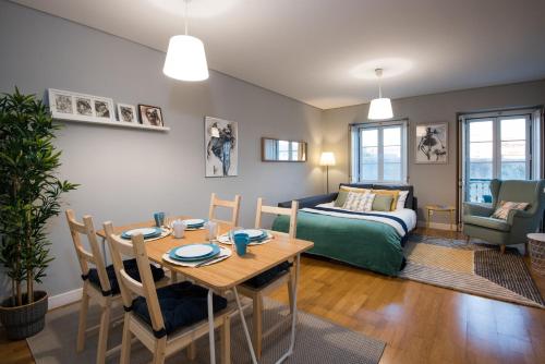 a living room with a table and a bed at Belém 147 Apartment in Lisbon