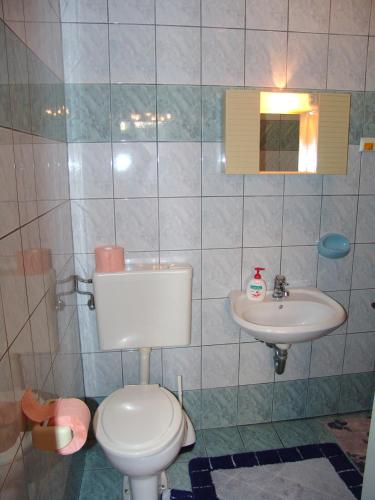 a bathroom with a toilet and a sink at Sobe Bozica in Krk