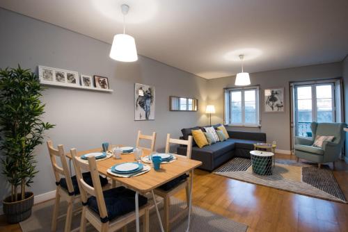 a living room with a table and a couch at Belém 147 Apartment in Lisbon