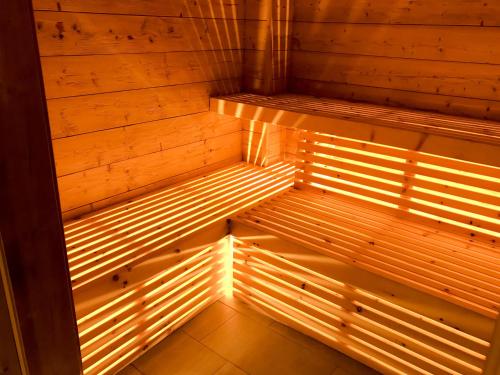 an empty sauna with a light on the inside at Hotel Al Lago in Soraga