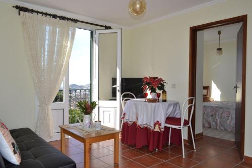 a living room with a table and a bed at Bela Vista in Funchal