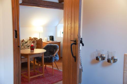 a door leading into a room with a table and a desk at Landlust Ischl in Bad Ischl