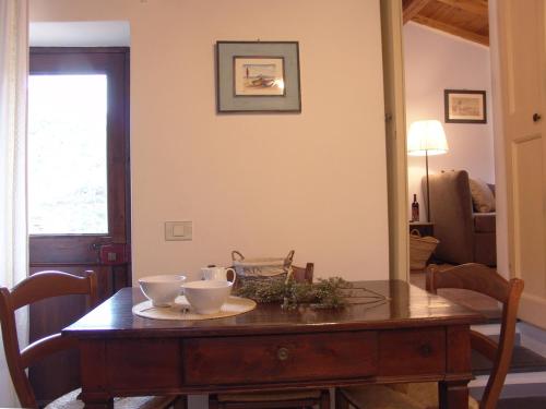 a dining room table with two bowls on it at Villanova Apartments - Nature & Wellness in Levanto