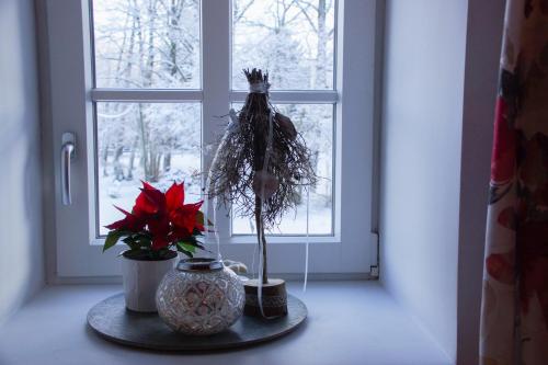 a window with a vase and flowers on a table at Landlust Ischl in Bad Ischl