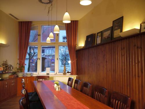 a dining room with a table and chairs and a window at Restaurant & Hotel Wismar in Wismar
