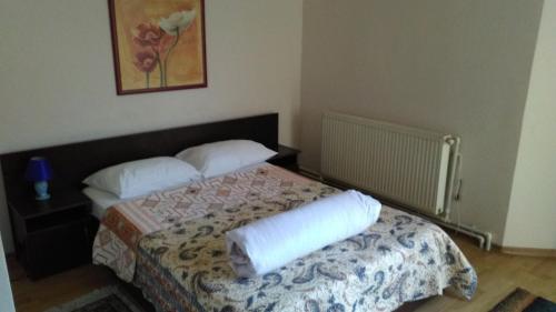 a bedroom with a bed with two pillows on it at Pensiunea SENA Focsani in Focşani