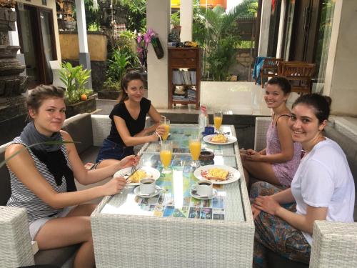 a group of women sitting around a table eating food at BBS Homestay in Nusa Lembongan