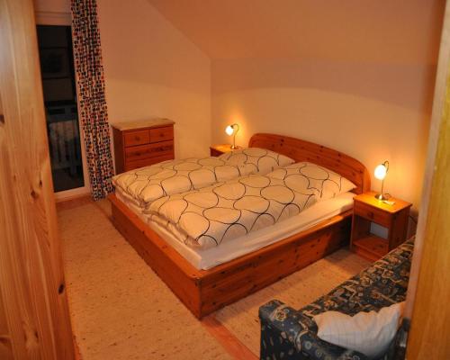 a bedroom with a large bed and two night stands at Ferienwohnung Regentalblick in Miltach