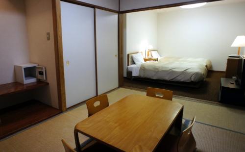 a hotel room with a table and a bed at Hakone Forest of Verde in Hakone