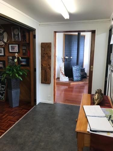 a living room with a table and a door at Tipi and Bobs Waterfront Lodge in Tryphena