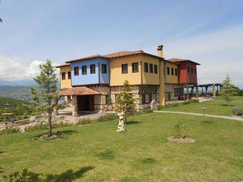 a house on top of a hill with a yard at Estate Kalaitzis in Vergina