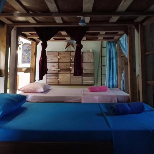 a bedroom with two beds in a room at Arjuna Garden Homestay in Yogyakarta