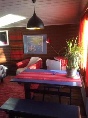 a living room with a table and a couch at Saarituvat Cottages in Rovaniemi