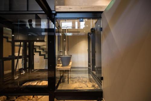 a glass door in a room with a pot on a table at Monastery Estate Venetian Harbor in Chania Town