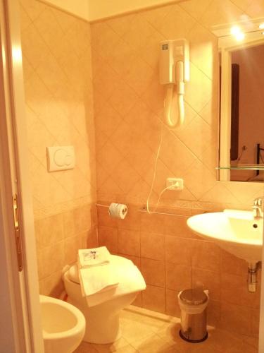 a bathroom with a toilet and a sink and a phone at Luconi Affittacamere in Iesi