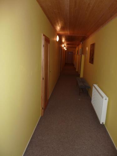 an empty hallway with yellow walls and a hallway sidx sidx sidx at Relax Centrum Gól in Loučná nad Desnou
