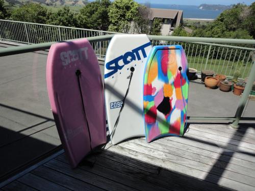 two surfboards are sitting on a balcony at Ocean View B&B in Whitianga