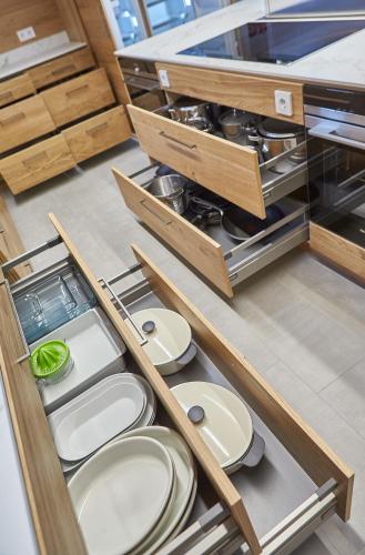 a kitchen with wooden drawers and white plates at Chalet Guter Hirte in Saalbach Hinterglemm