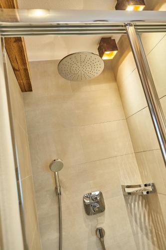 a shower with a glass door in a bathroom at Chalet Guter Hirte in Saalbach Hinterglemm