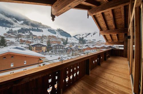 a balcony with a view of a snowy mountain at Chalet Guter Hirte in Saalbach Hinterglemm