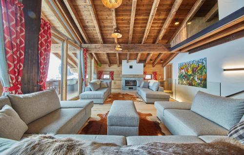 a living room with couches and a fireplace at Chalet Guter Hirte in Saalbach Hinterglemm
