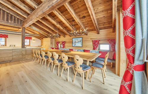 a dining room with a long table and chairs at Chalet Guter Hirte in Saalbach Hinterglemm