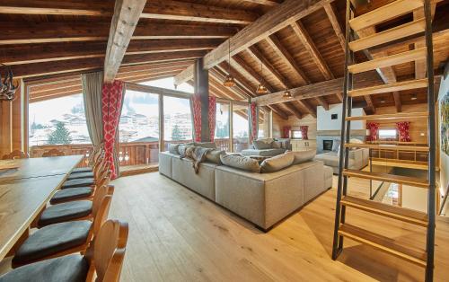 a living room with a couch and a table at Chalet Guter Hirte in Saalbach Hinterglemm
