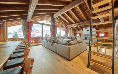 a living room with a couch and a table at Chalet Guter Hirte in Saalbach-Hinterglemm