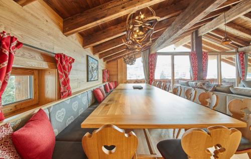 a dining room with a long table and chairs at Chalet Guter Hirte in Saalbach Hinterglemm