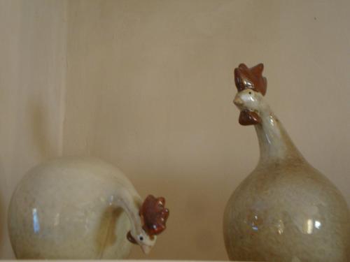 two white vases sitting on top of a shelf at La Guéritaulde in La Tour-dʼAigues