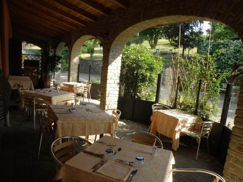 an outdoor restaurant with tables and chairs and windows at Madonna della Neve in Cessole