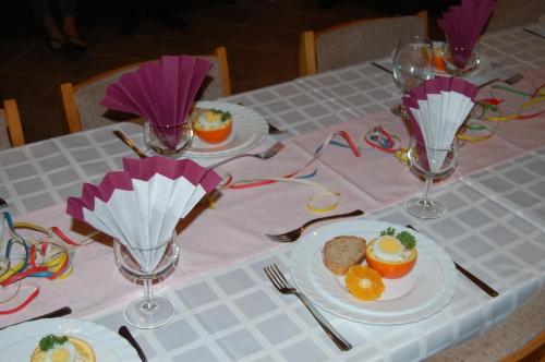 a table with plates of food and wine glasses at Judit Panzio in Gyulakeszi