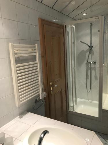 a bathroom with a sink and a shower and a mirror at Ferienwohnung Franziska 2 in Garmisch-Partenkirchen
