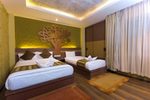 Postel nebo postele na pokoji v ubytování Bodhi Boutique Hotel