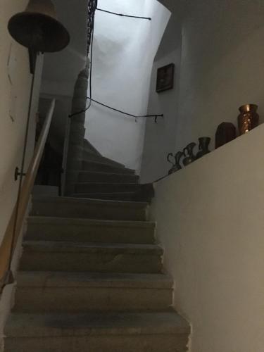 a staircase in a house with a white wall at Pension Sunnseitn - Gasthof - Café - Weinkeller in Haslach an der Mühl